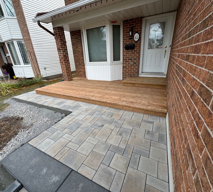Front entrance with stonework and wooden patio